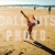 Boy Doing Hand Stand on Beach