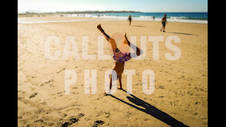 Boy Doing Hand Stand on Beach