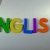 Hand Writes English with Fridge Magnets Close-Up