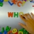 Hand Writes Who with Fridge Magnets