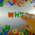 Hand Writes Why with Fridge Magnets