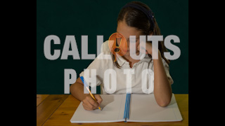 Student Writing in Notebook in Front of Green Chalkboard