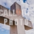 Heavy Stone Cross with Cloudy Sky Backdrop