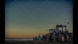 Tractors on Beach at Sunset
