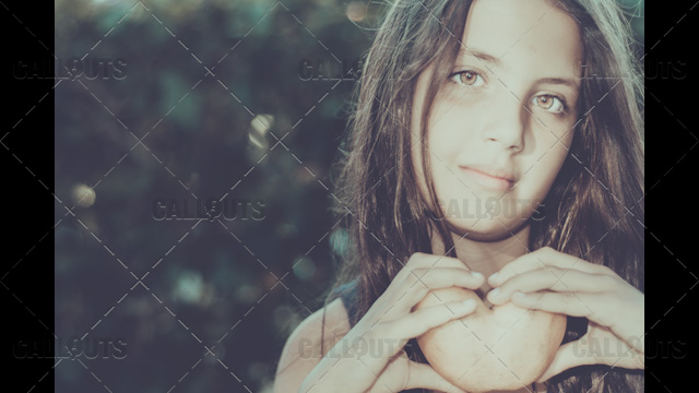 Girl holds Heart-Shaped Potato