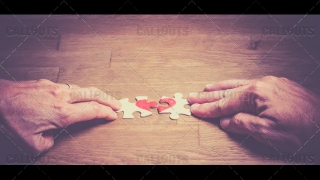 Hands Putting Love Puzzle Together