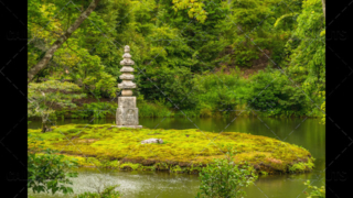 Japanese stone pagoda on an island in a garden pond or lake