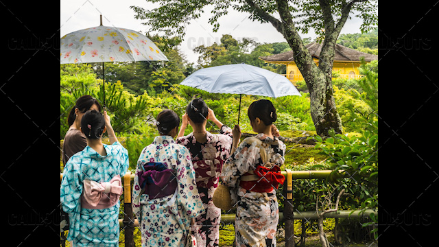 Japanese tourists dressed in traditional kimono dresses visiting tourist attraction