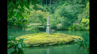 Stone pagoda on small island, in lake or pond