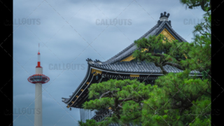 Kyoto tourist attractions. Higashi Hongan-ji Temple roof with Kyoto Tower in the background.