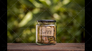 A Jar with Coins with a Save Note Inside, Centered