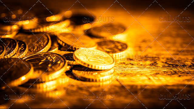 Shimmering Coins on Wood Table