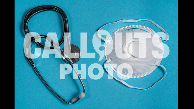 Stethoscope and Protective Face Mask on Blue Surface