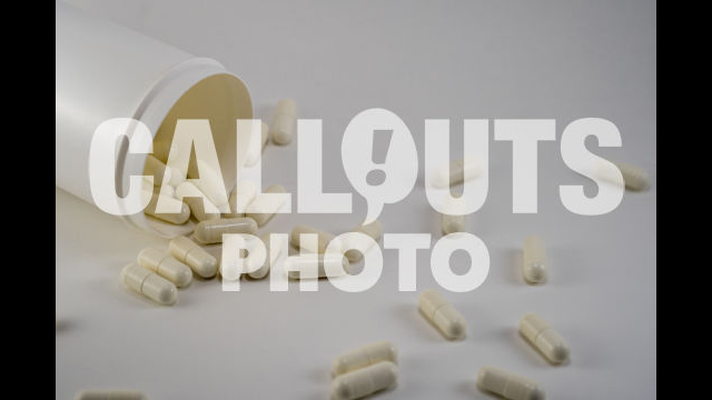 Plastic Medicine Bottle with White Medicine or Supplements Pouring Out Wide