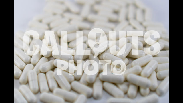 Pile of White Medicine or Supplements, White Background, Shallow Depth-of-Field