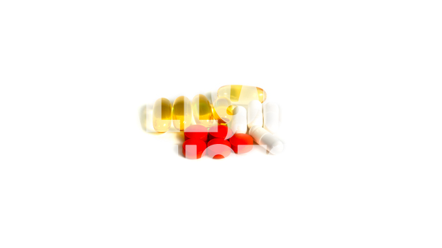 Various Supplements and Vitamins Centered on White Background, Text Space