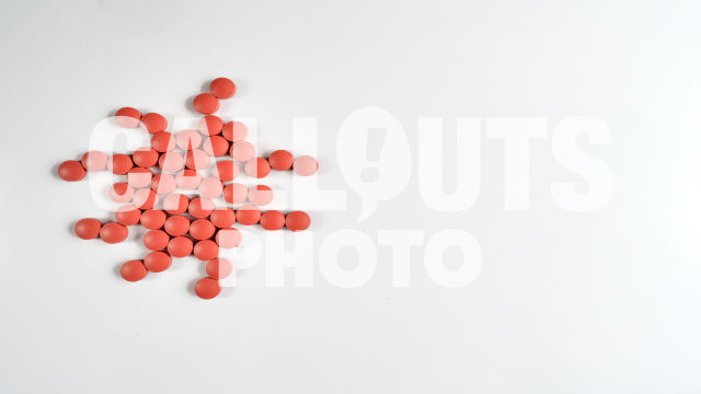 Red Medicine or Supplement Pills Forming Virus Shape on White Background, Text Space