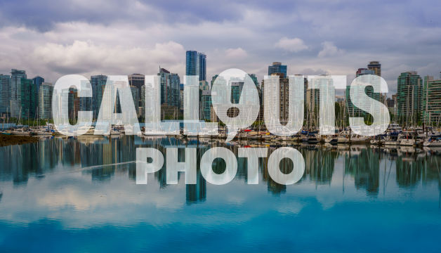 Vancover skyline, with harbour, and boats reflecting in ocean