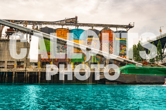 Colorful painted silos by river in Vancouver (Lic. Ed. Use Only)