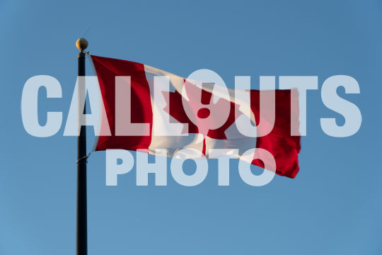 Canadian flag agains blue sky