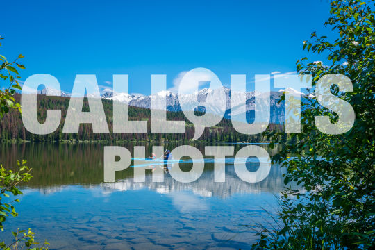 Canoe on Pyramid Lake with mountains and forest, (Lic. Ed. Use Only)